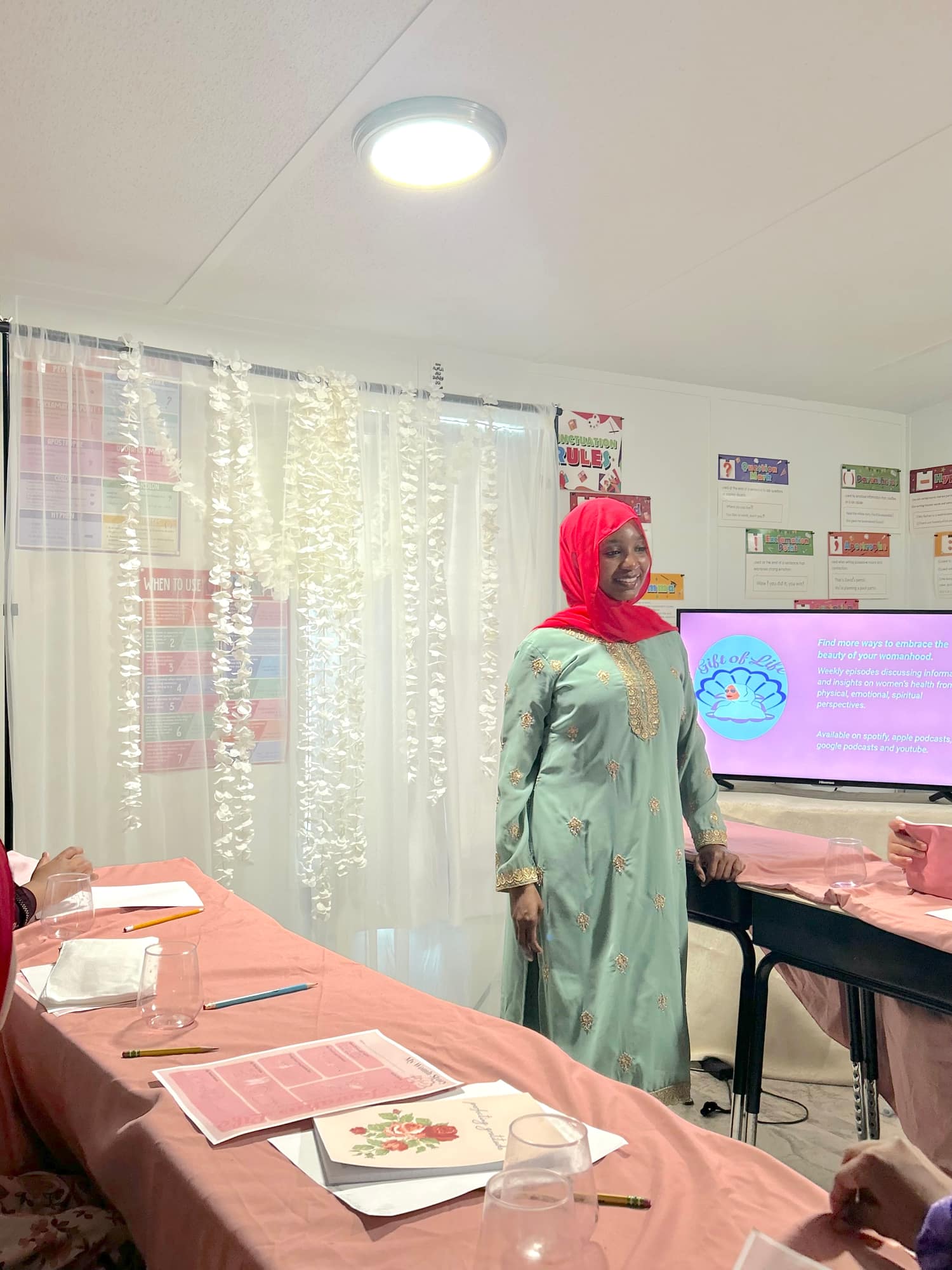 Ayana Shahid presenting to the room in front of a screen