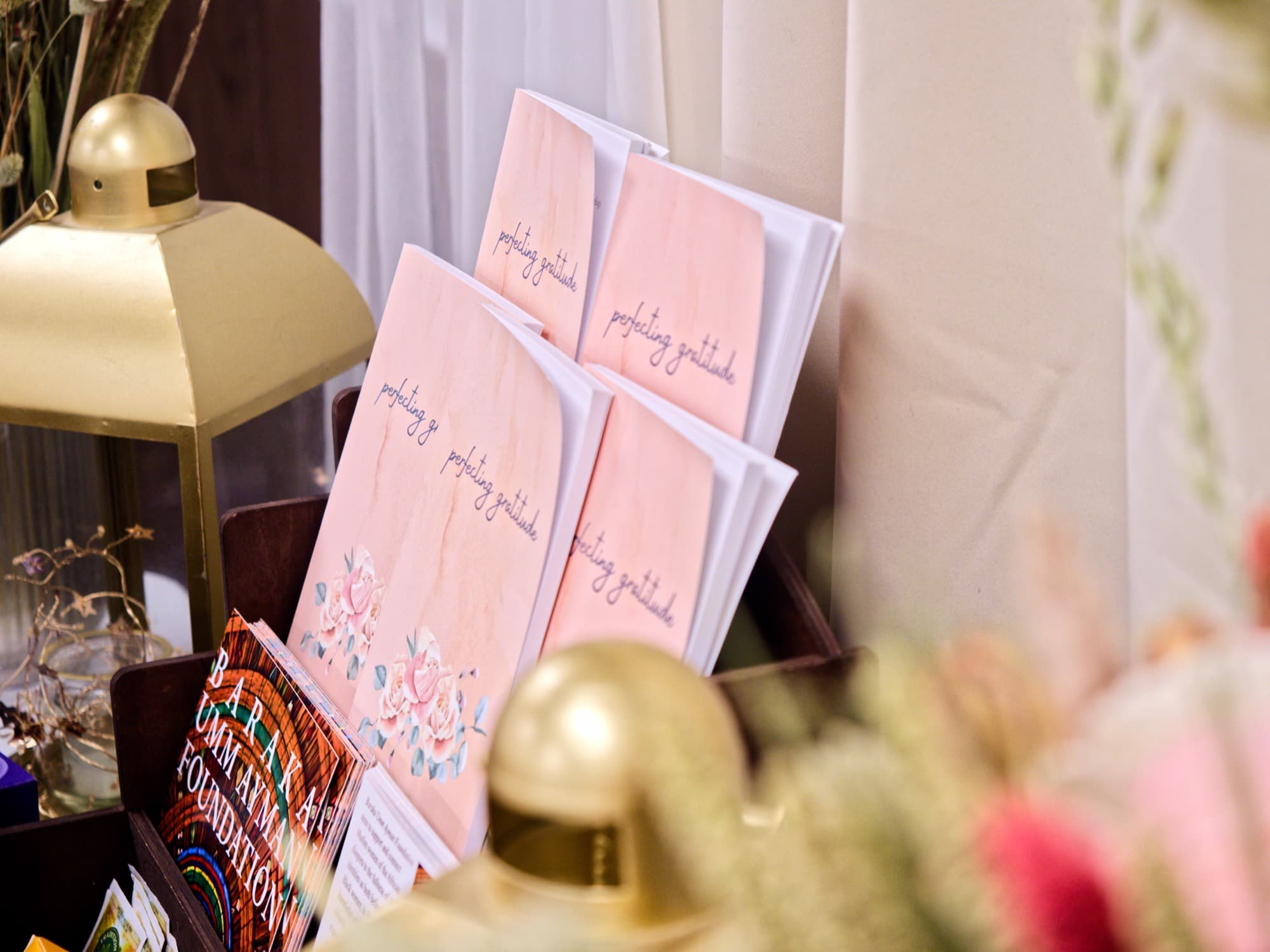 Copies of the Perfecting Gratitude book displayed on a table
