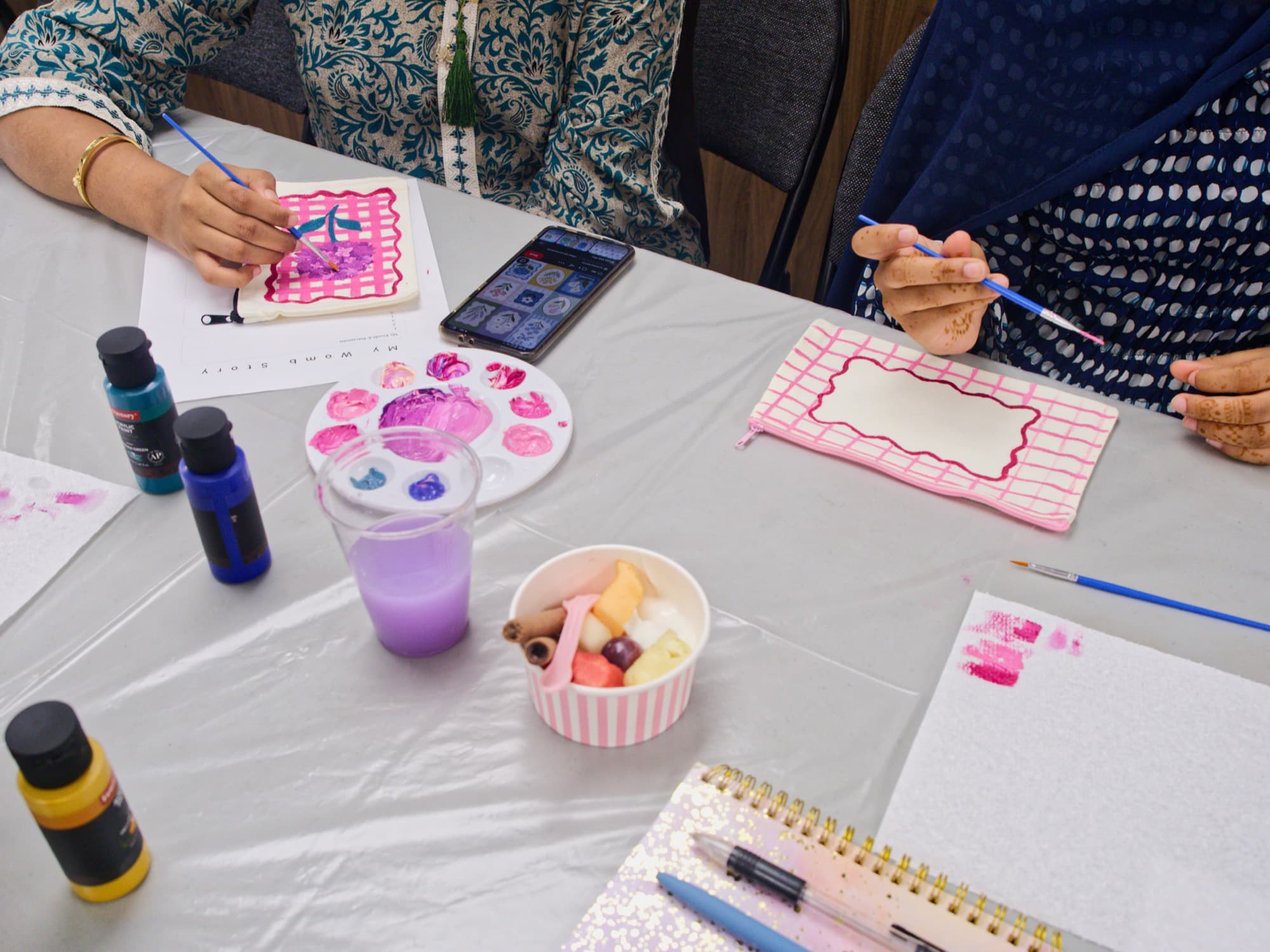 Paint palettes and hand-painted designs in progress